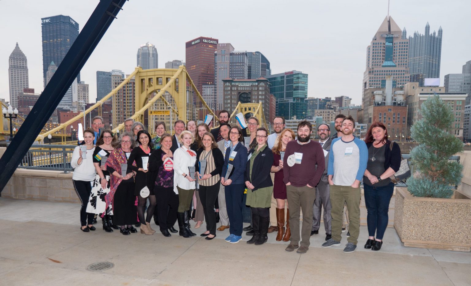 Group of 2019 Sustainable Award winners standing north of Allegheny River with Downtown Pittsburgh in the background