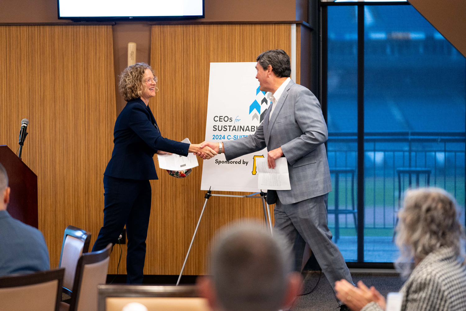 Jana Lake, President of 3R Sustainability and CEOs for Sustainability Co-Chair, and Bob Nutting shake hands on stage.