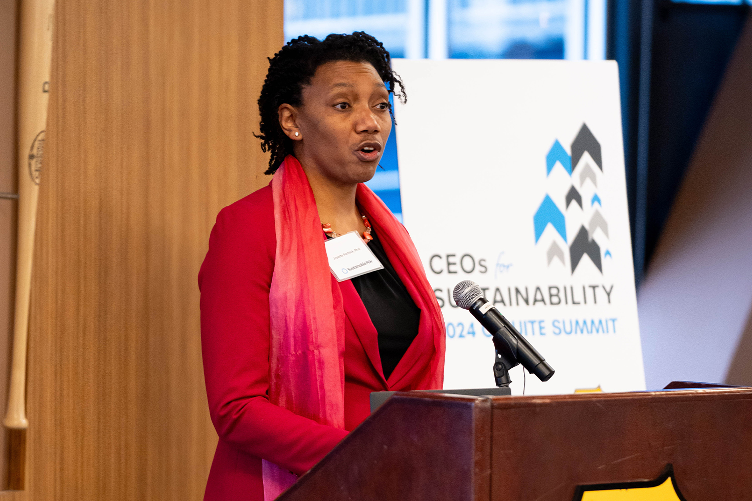 Joylette Portlock, Ph.D., Executive Director of Sustainable Pittsburgh, stands at the podium delivering closing remarks.